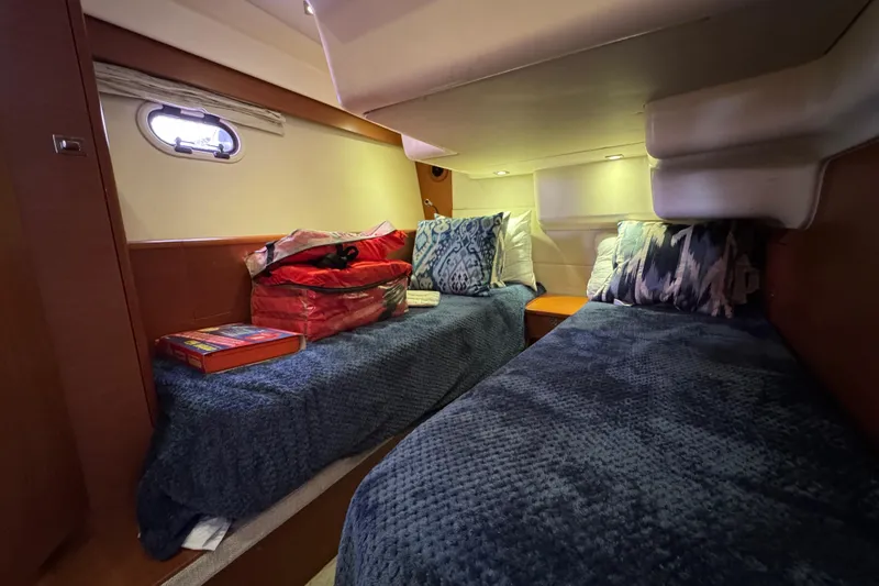 Slide: The Image of Cozy cabin interior of 2014 Prestige 400 yacht with twin beds and decorative pillows. - 19