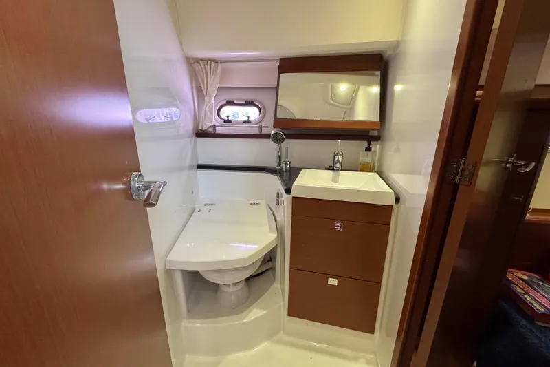 Slide: The Image of Compact bathroom in 2014 Prestige 400 yacht with modern fixtures and wooden cabinetry. - 20