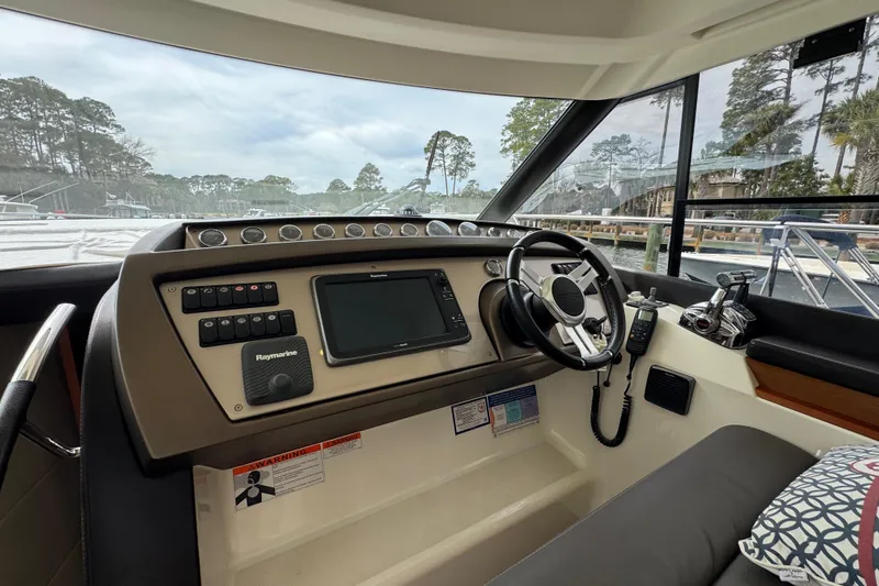 Slide: The Image of Helm of 2014 Prestige 400 yacht with navigation controls and steering wheel. - 26