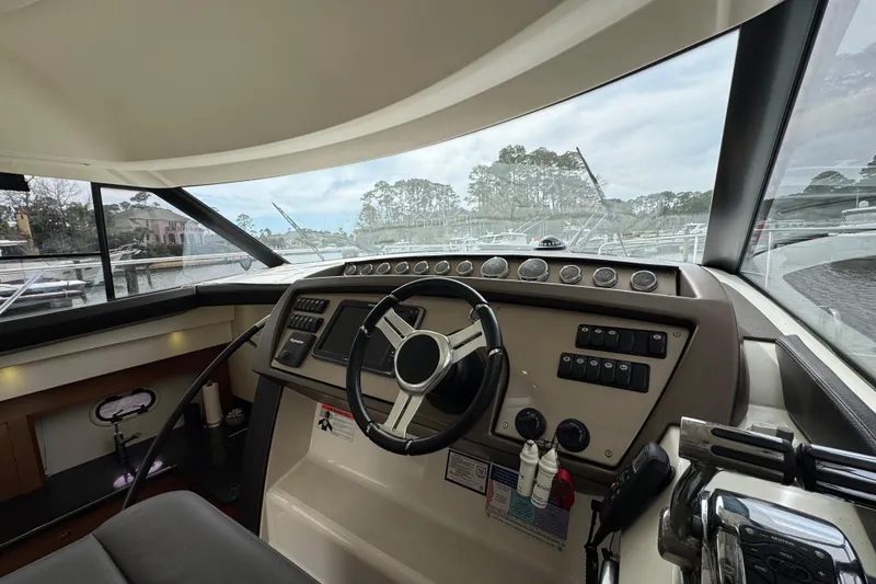 Slide: The Image of Interior view of a 2014 Prestige 400 yacht helm with steering wheel and control panel. - 28