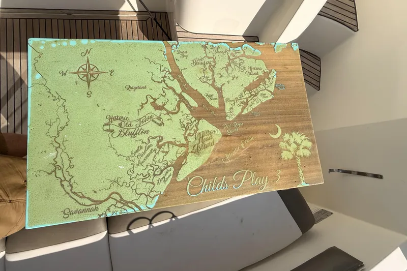 Slide: The Image of Map-themed table on a 2014 Prestige 400 yacht, featuring coastal locations and compass rose. - 33