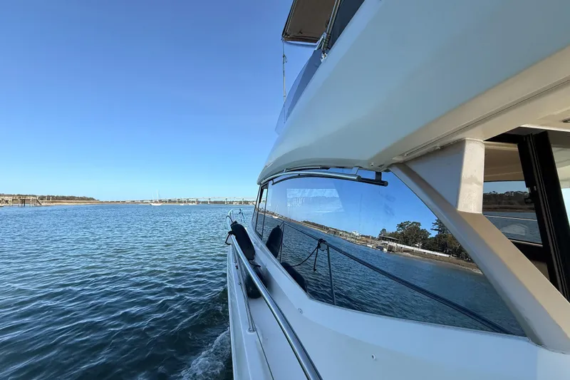 Slide: The Image of Prestige 400 yacht cruising on calm waters, 2014 model, clear blue sky. - 35