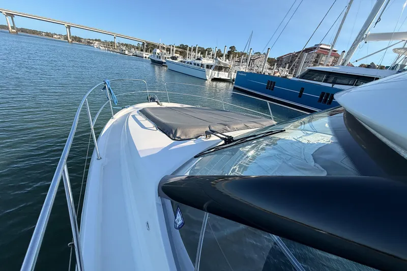 Slide: The Image of 2014 Prestige 400 yacht docked in marina, clear sky, calm water. - 36