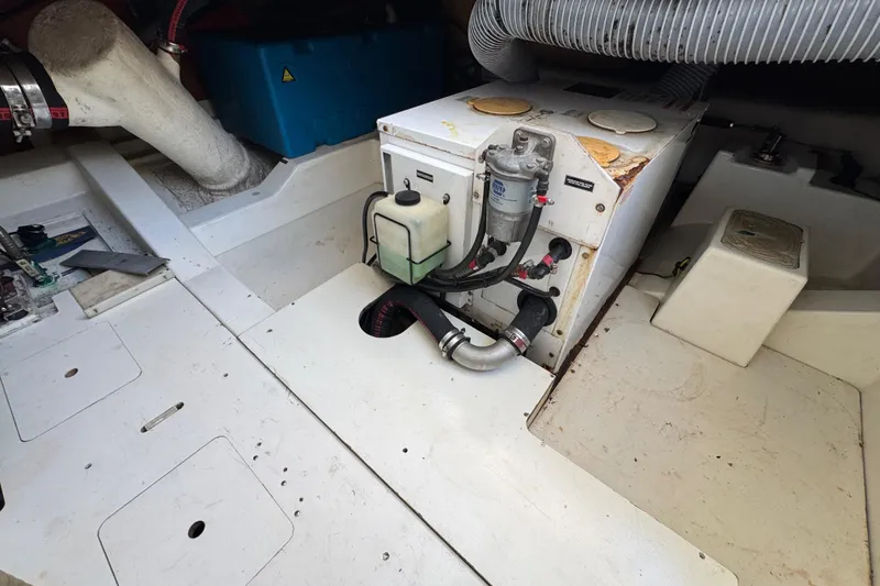 Slide: The Image of Engine compartment of a 2014 Prestige 400 boat, featuring mechanical components and hoses. - 38