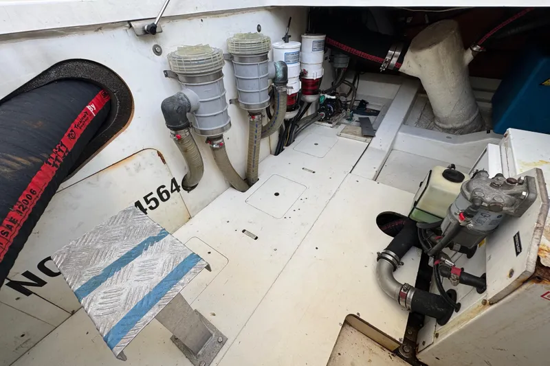 Slide: The Image of Engine compartment of a 2014 Prestige 400 boat, showcasing mechanical components and hoses. - 40