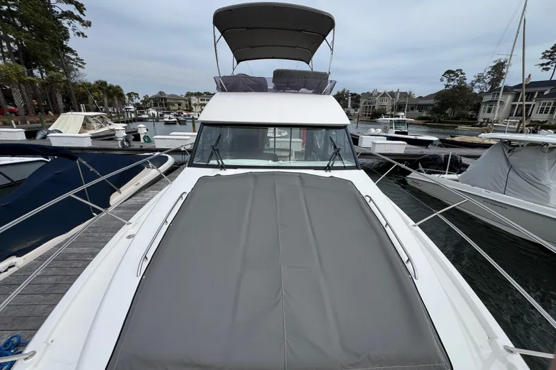 Slide: The Image of 2014 Prestige 400 yacht docked at marina, featuring sleek design and spacious deck. - 5