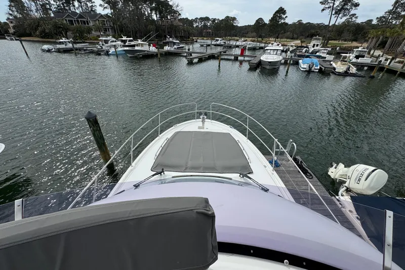 Slide: The Image of Prestige 400 yacht docked in a marina, surrounded by other boats, 2014 model. - 7