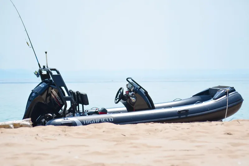 Slide: The Image of Manufacturer Provided Image: 2025 Highfield Sport 420 boat on sandy beach with calm sea background. - 2