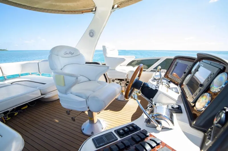 Slide: The Image of 2005 Sea Ray 420 Sedan Bridge yacht helm with luxurious seating and advanced navigation systems. - 13