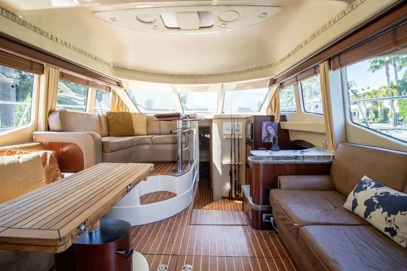 Slide: The Image of Luxurious interior of 2005 Sea Ray 420 Sedan Bridge yacht with elegant seating and wood finishes. - 5