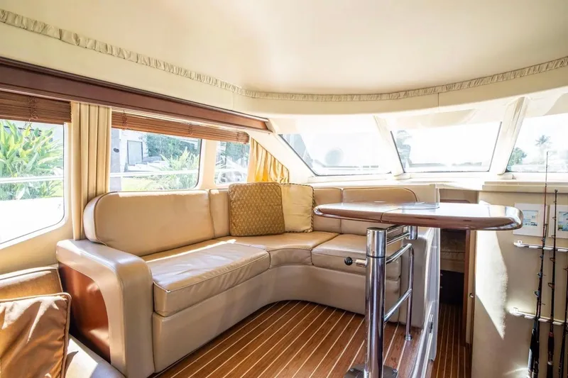 Slide: The Image of Luxurious interior of 2005 Sea Ray 420 Sedan Bridge yacht with leather seating and wooden accents. - 6