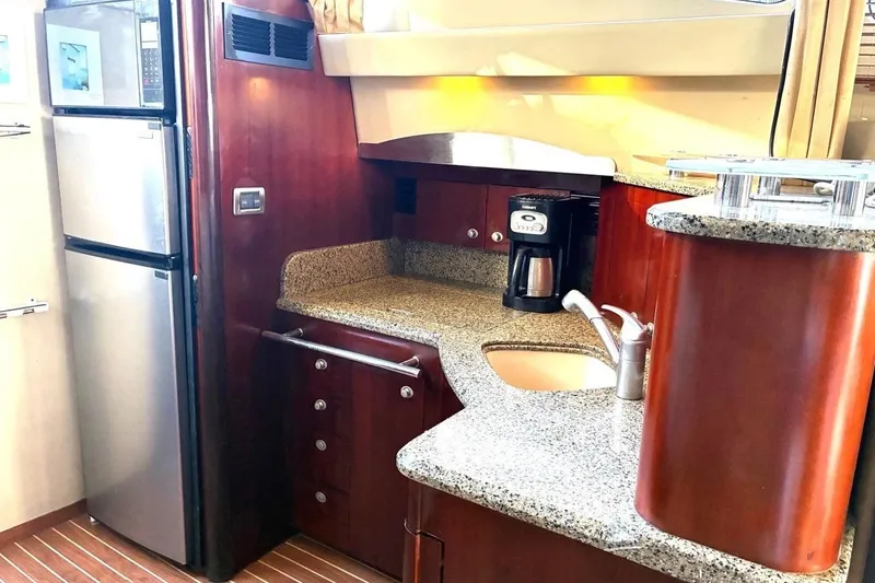 Slide: The Image of Luxurious 2005 Sea Ray 420 Sedan Bridge yacht kitchen with granite countertops and modern appliances. - 8