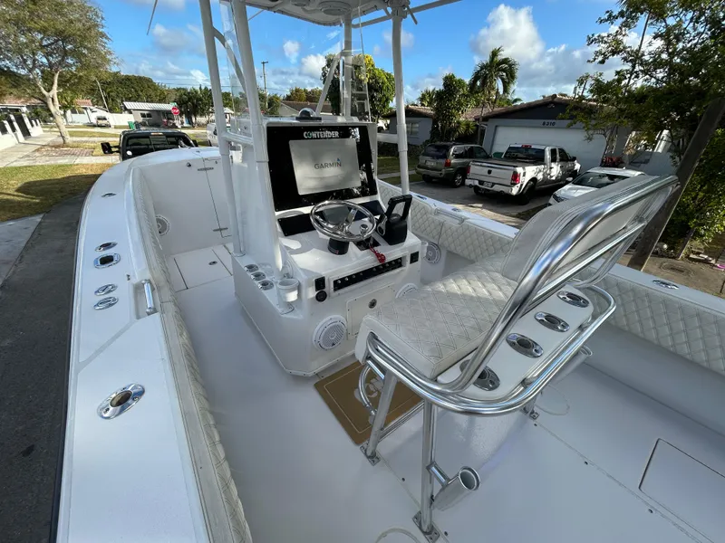 Slide: The Image of 2001 Contender 27' cuddy boat interior with steering console and seating. - 7