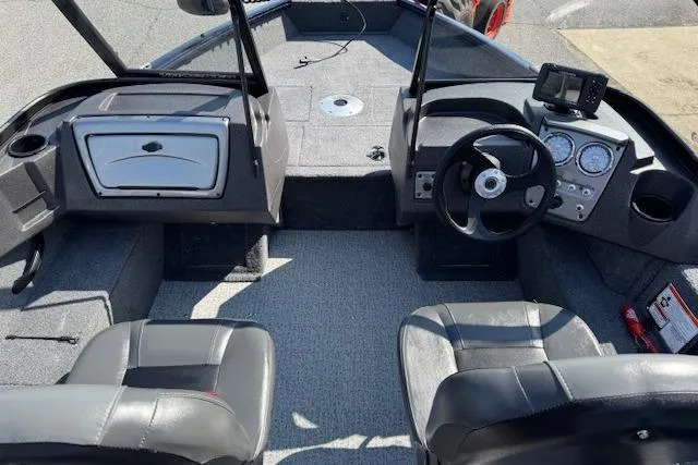 Slide: The Image of 2023 Tracker Pro Guide V-16 WT boat interior with steering wheel and seating. - 10