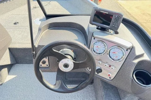 Slide: The Image of 2023 Tracker Pro Guide V-16 WT boat dashboard with steering wheel and navigation system. - 11