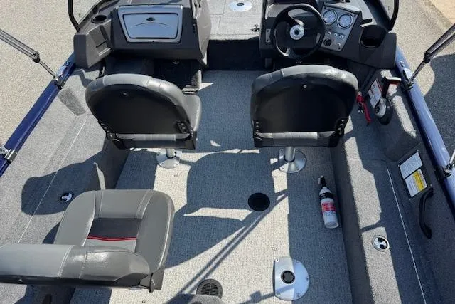 Slide: The Image of 2023 Tracker Pro Guide V-16 WT boat interior with seating and steering console. - 13