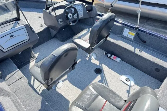 Slide: The Image of 2023 Tracker Pro Guide V-16 WT boat interior with seating and steering console. - 15