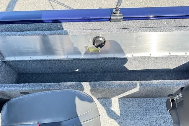 Slide: The Image of 2023 Tracker Pro Guide V-16 WT interior with seating and storage compartment. - 18