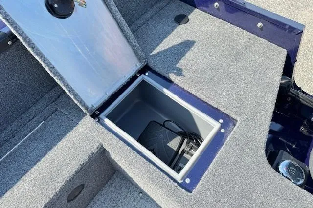 Slide: The Image of 2023 Tracker Pro Guide V-16 WT boat storage compartment with open lid and visible battery. - 19