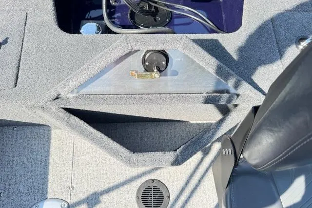 Slide: The Image of 2023 Tracker Pro Guide V-16 WT boat interior with storage compartment and seat detail. - 20