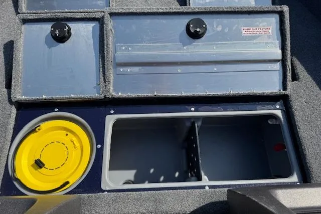 Slide: The Image of 2023 Tracker Pro Guide V-16 WT boat storage compartments with yellow bucket and gray interior. - 9