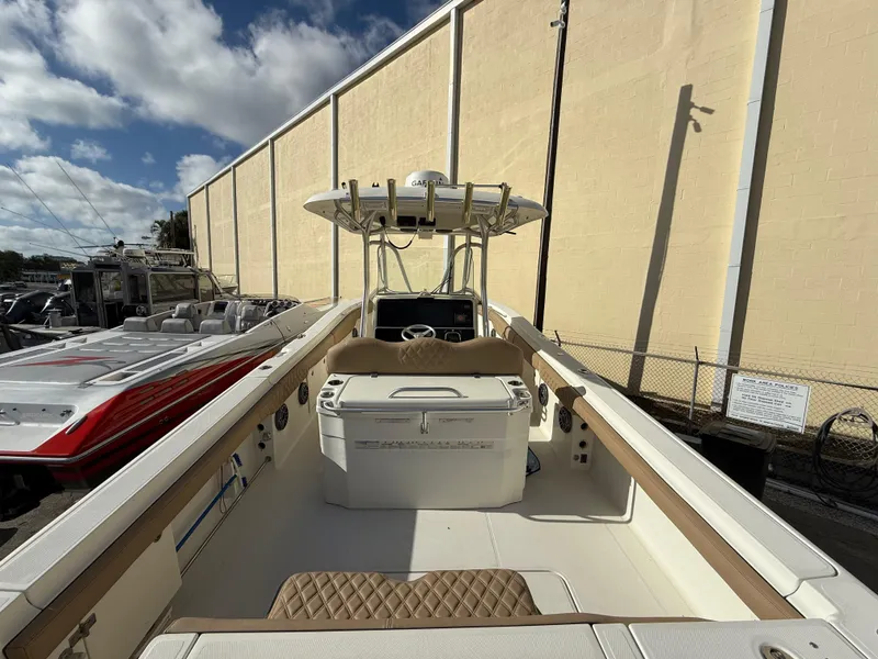Slide: The Image of 2006 Hydra-Sports Vector 3300 CC boat, center console, docked under a partly cloudy sky. - 11