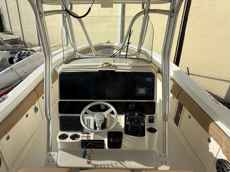 Slide: The Image of 2006 Hydra-Sports Vector 3300 CC boat cockpit with steering wheel and control panel. - 14