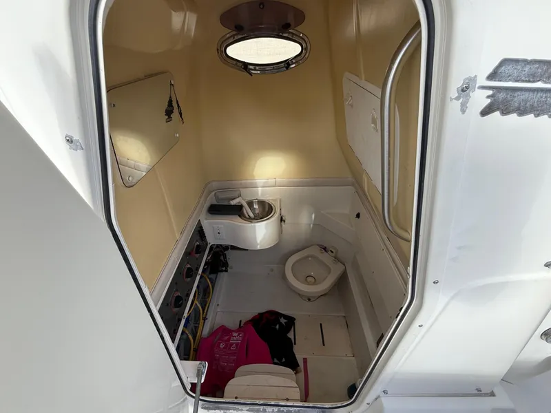 Slide: The Image of 2006 Hydra-Sports Vector 3300 CC boat cabin interior with toilet and sink. - 15