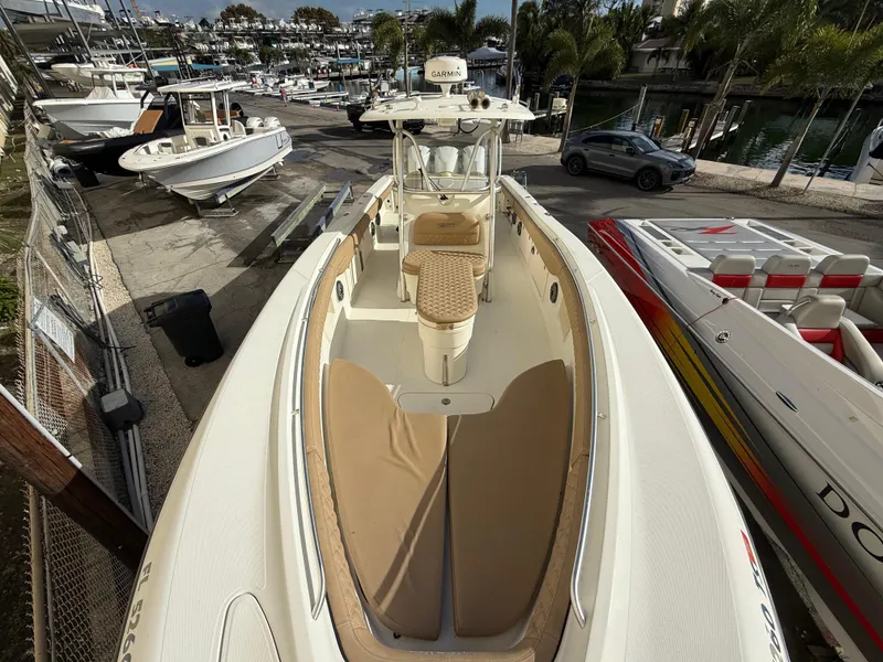Slide: The Image of 2006 Hydra-Sports Vector 3300 CC boat docked, showcasing spacious deck and seating area. - 18