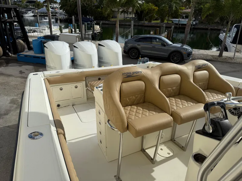 Slide: The Image of 2006 Hydra-Sports Vector 3300 CC boat with tan leather seats and triple outboard engines. - 22