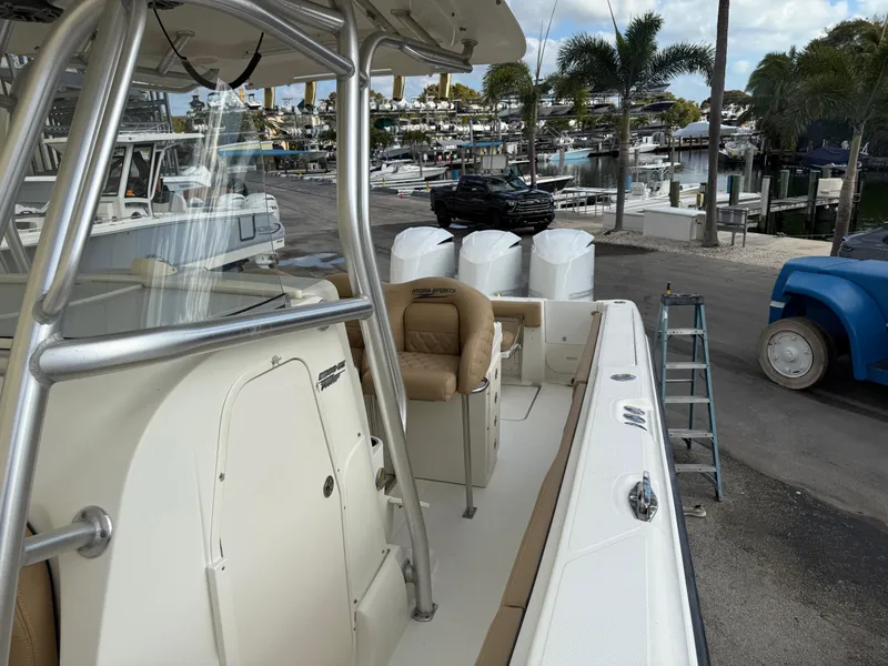 Slide: The Image of 2006 Hydra-Sports Vector 3300 CC boat docked at a marina with palm trees. - 24