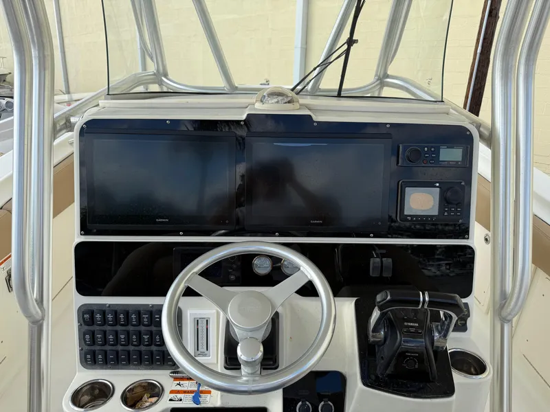 Slide: The Image of 2006 Hydra-Sports Vector 3300 CC boat dashboard with steering wheel and electronic controls. - 26