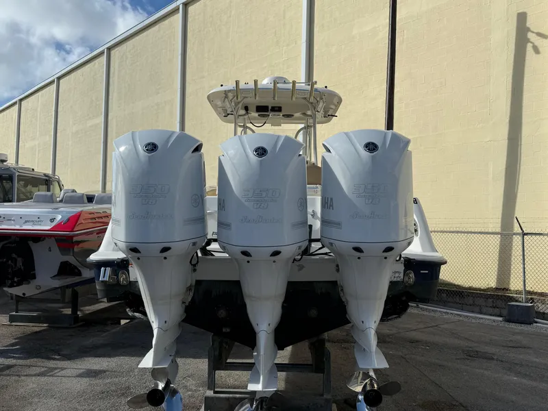 Slide: The Image of 2006 Hydra-Sports Vector 3300 CC with triple outboard engines, parked outdoors. - 29