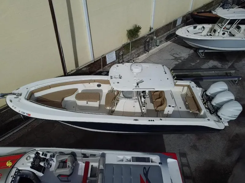 Slide: The Image of 2006 Hydra-Sports Vector 3300 CC boat with triple engines, docked in a marina. - 3