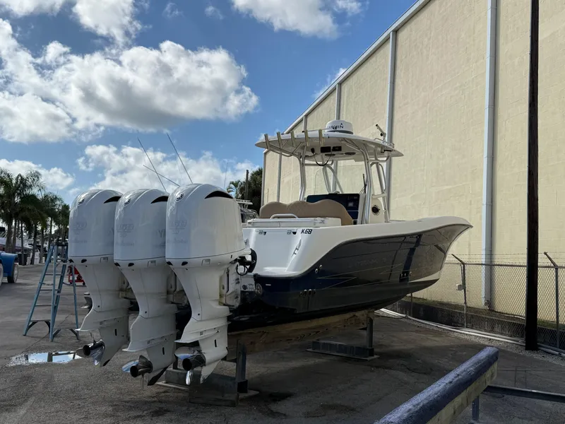 Slide: The Image of 2006 Hydra-Sports Vector 3300 CC boat with triple outboard engines, docked outdoors. - 31