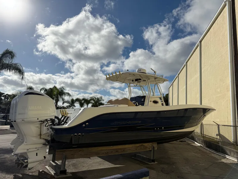 Slide: The Image of 2006 Hydra-Sports Vector 3300 CC boat with Yamaha engines, docked under a cloudy sky. - 9