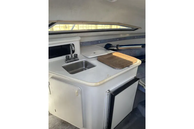 Slide: The Image of 1993 Monterey 250 Cruiser interior with compact kitchenette and sink. - 6