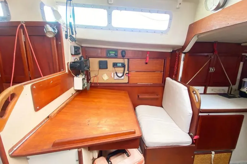 Slide: The Image of 1975 Whitby 42 Ketch interior with navigation station and wooden cabinetry. - 11