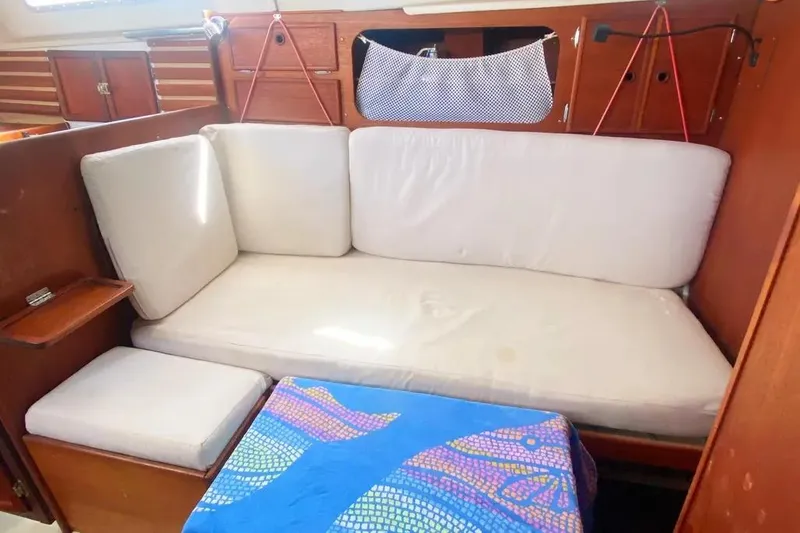 Slide: The Image of Interior of 1975 Whitby 42 Ketch with cushioned seating and wooden cabinetry. - 16