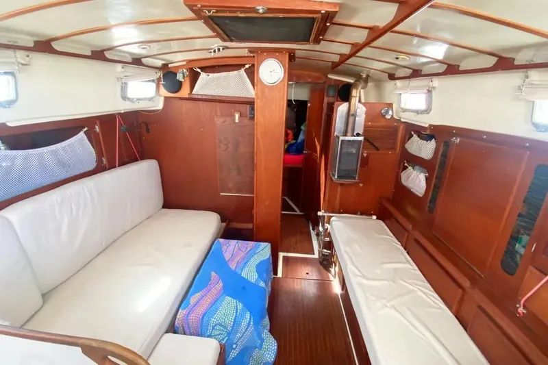 Slide: The Image of Interior of 1975 Whitby 42 Ketch sailboat with wooden finish and cozy seating. - 18