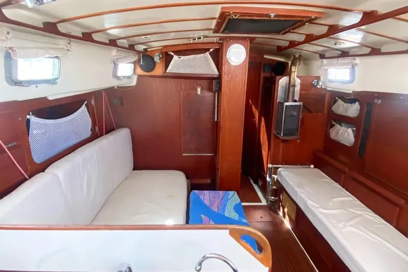 Slide: The Image of Interior of 1975 Whitby 42 Ketch sailboat with wooden finish and cozy seating. - 19