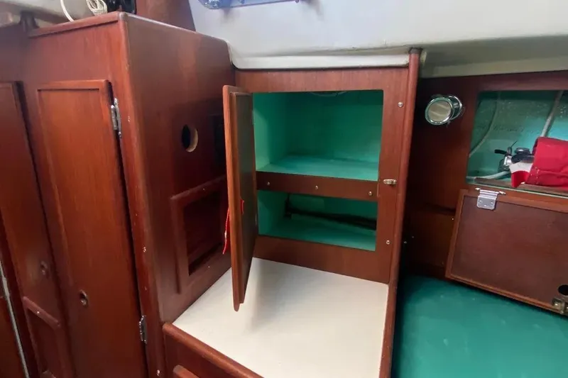 Slide: The Image of Interior of 1975 Whitby 42 Ketch showing wooden cabinetry and storage space. - 21
