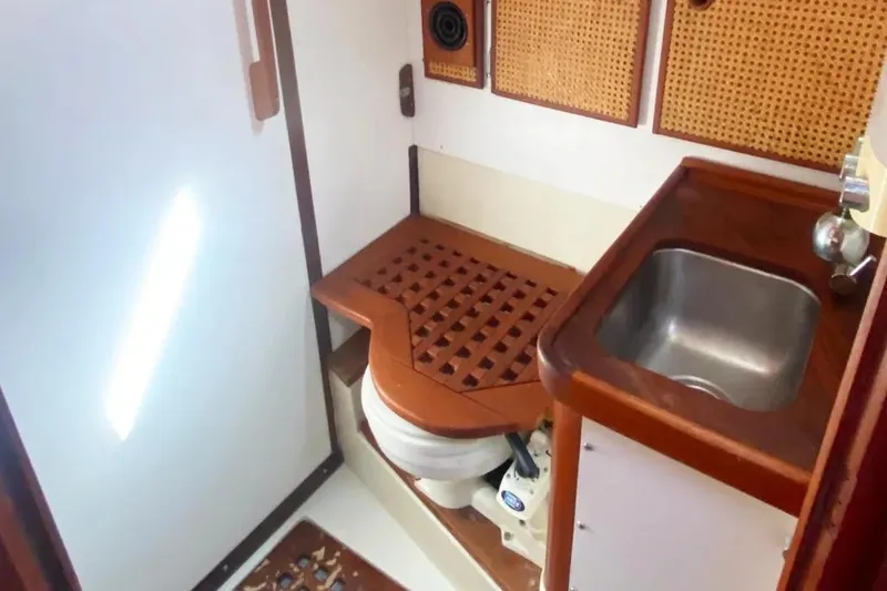 Slide: The Image of 1975 Whitby 42 Ketch bathroom with wooden accents and compact sink. - 24