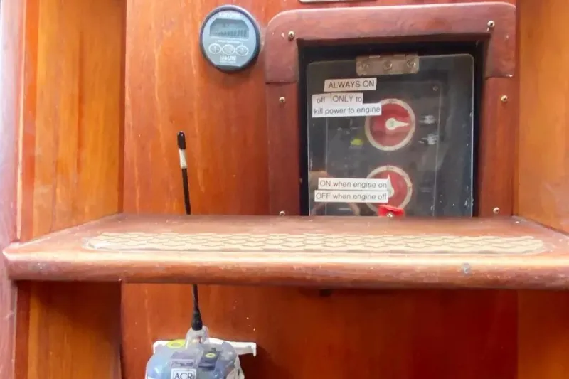 Slide: The Image of Control panel of a 1975 Whitby 42 Ketch sailboat with engine switches and labels. - 30