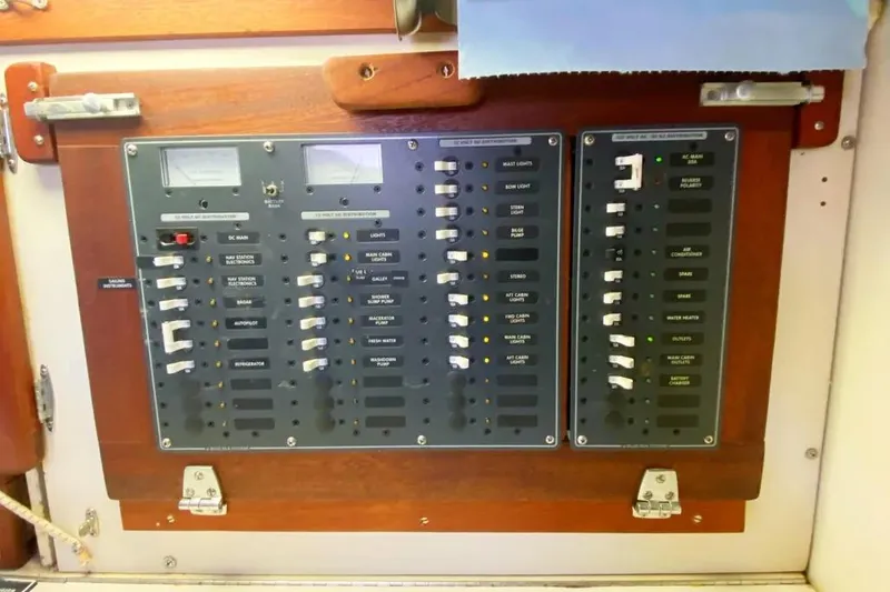 Slide: The Image of Electrical control panel on a 1975 Whitby 42 Ketch sailboat, featuring various switches and meters. - 33