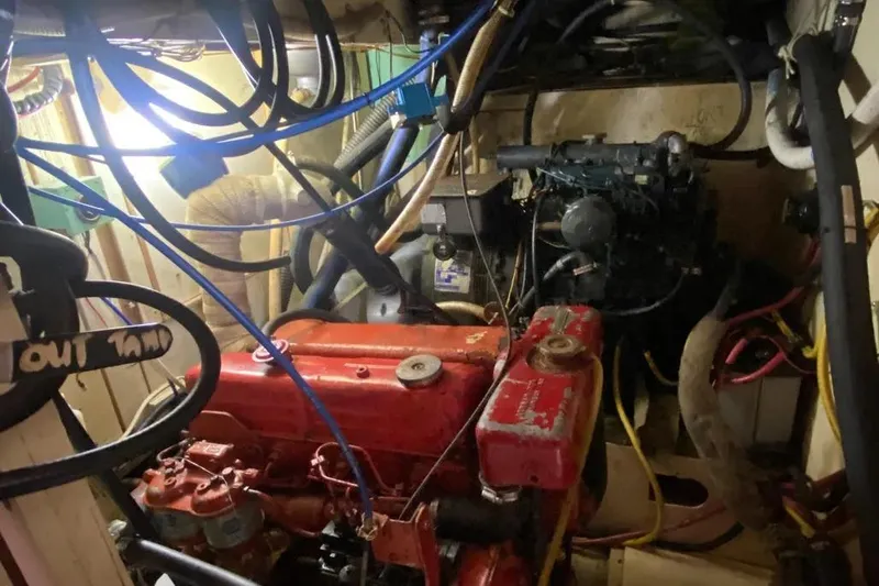 Slide: The Image of Engine room of a 1975 Whitby 42 Ketch with visible wiring and components. - 38