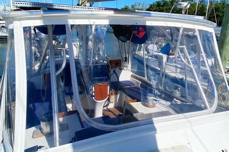 Slide: The Image of 1975 Whitby 42 Ketch sailboat cockpit with clear enclosure, docked at marina. - 5