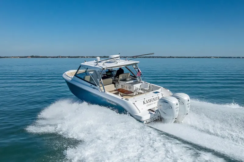 Slide: The Image of 2019 Everglades 340 Dual Console boat cruising on open water. - 13