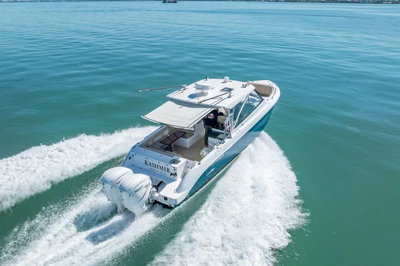 Slide: The Image of 2019 Everglades 340 Dual Console boat cruising on open water. - 20