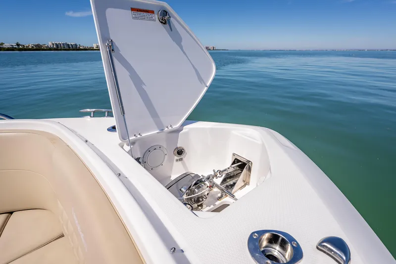 Slide: The Image of 2019 Everglades 340 Dual Console boat with open anchor compartment on calm water. - 22